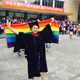 Wan celebrates after the ceremony, waving her flag.